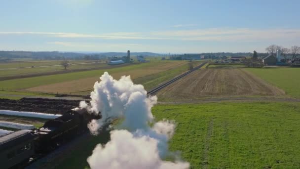 2022年2月1日ペンシルベニア州ロンクス 蒸気機関車の上下からのドローンビュー 農場を旅して煙を吹いて 晴れた冬の日に — ストック動画