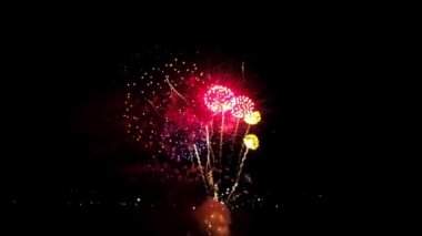 A Drone View of July 4th Fireworks, Captured at Half Speed, With Multiple Bursts in all Colors on a Calm Summer Night