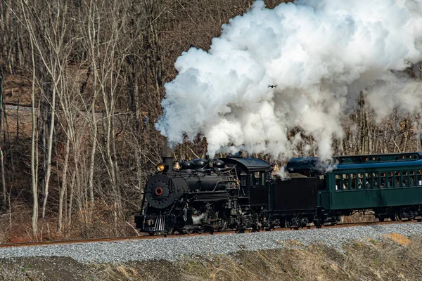 stock image View of a Narrow Gauge Restored Steam Passenger Train Blowing Smoke and Traveling Thru Farmlands on a Winter Day