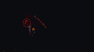 A Drone View of July 4th Fireworks, Captured at Half Speed, With Multiple Bursts in all Colors on a Calm Summer Night