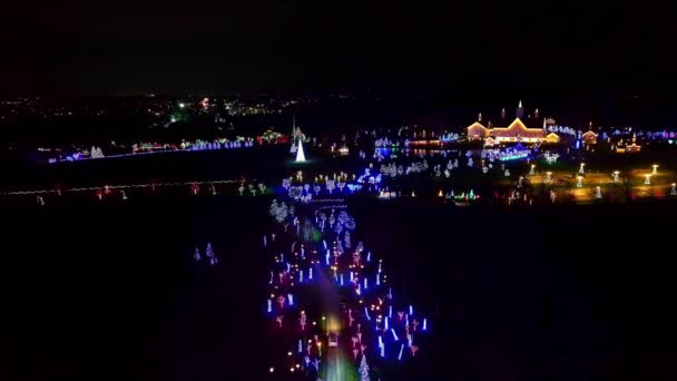 ライトが付いている大きいクリスマスの表示の空中眺めは木 スラブ ドライブのための建物の照明を導きました — ストック動画