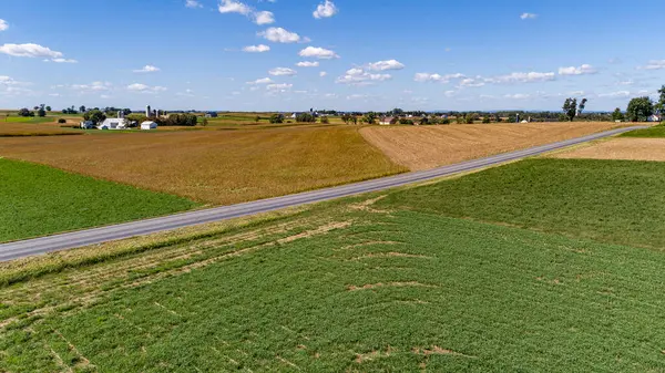 stock image An Aerial View of a Patchwork of Fields of Crops Growing, and a Farm Homestead, on a Sunny Autumn Day