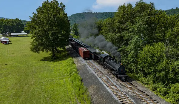 stock image An Aerial View of a Narrow Gauge Steam Passenger Train, Approaching Traveling Thru Countryside, Blowing Smoke, on a Sunny Summer Day