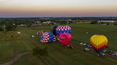 Bird in Hand, Pennsylvania, USA, September 14, 2023 - An Aerial View on Many Hot Air Balloons Launching, in the Early Morning, From a Field in Rural America, on a Sunny Summer Day