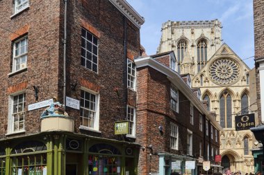 York, United Kingdom - June 17, 2022: York cathedral and historical shopping street High Petergate in York, UK on June 17, 2022. clipart