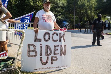 Atlanta, GA / USA - August 24, 2023:  A man holds a large sign that says 