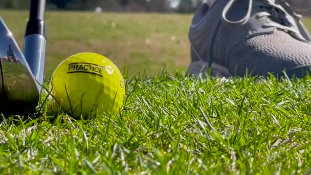 スローモーションショーゴルフクラブがゴルフ運転範囲で黄色い練習ボールを打つクローズアップ — ストック動画