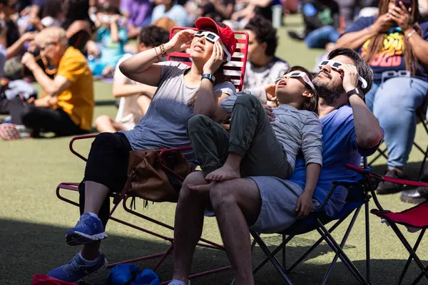 美国亚特兰大 2024年4月8日 2024年4月8日 在美国亚特兰大举行的一个观察日全食的聚会上 一家人戴着特殊的眼镜观看日全食 免版税图库图片