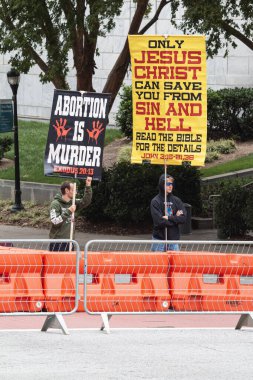 Atlanta, GA / USA - October 15, 2023:  Anti-gay, right-wing activists display hateful signs as they await the pride parade to pass in front of them on October 15, 2023 in Atlanta, GA. clipart