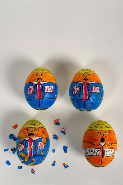 stock image Lawrenceville, GA / USA - June 2, 2024: Cartoonish drawings on eggs crack, showing the 