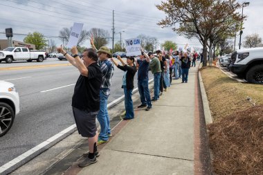 Duluth, GA / USA - 29 Mart 2025: Düzinelerce protestocu, 29 Mart 2025 'te Duluth, GA' da düzenlenen bir Tesla protesto etkinliğinde Elon Musk karşıtı tabelalar sergiliyor..