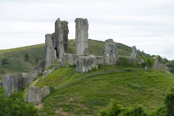 View of the ruins of Corfe Castle on an overcast day