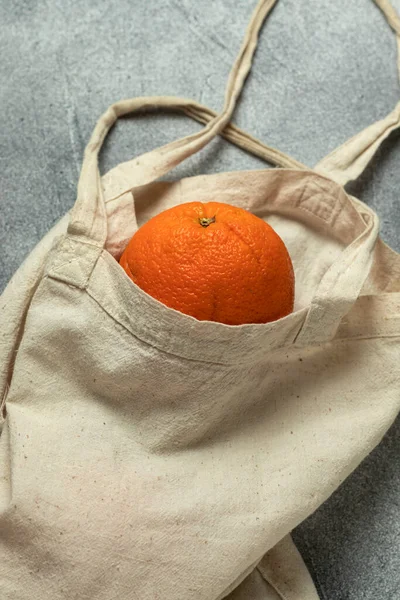 Linen bag with organic ripe oranges. Top view.