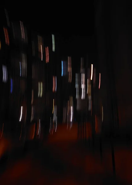 Abstract night photo of a residential building. Motion blur.