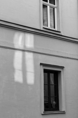 Pencereler ve pencereler eski bir evin yansıması. Minimalist siyah beyaz sokak fotoğrafı.
