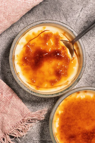 Creme brulee (burnt cream). Dessert consisting of a custard base topped with a layer of hardened caramelized sugar.