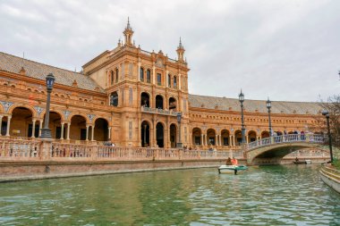 SEVILLA, SPAIN - JANUARY 1, 2023: Boats on Spain Square channel (Plaza de Espana), built on 1928 the Regionalism Architecture with Renaissance and Moorish styles in Sevilla, Spain on January 1, 2023