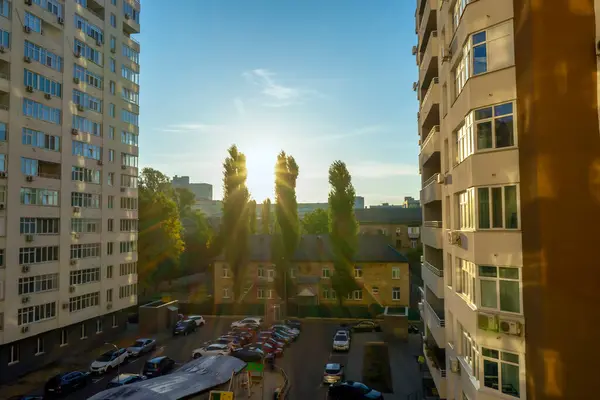 KYIV, UKRAINE - 15 Ekim 2023: 15 Ekim 2023 'te Ukrayna' nın Kyiv kentinde ağaçlar ve binalar arasında gün doğumu. 