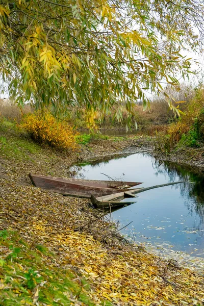 Boat on autumn river in Poltava region. Autumn Ukrainian landscape