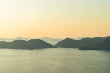 Panoramic view of range of mountains, hills in Fethiye from the Butterfly Valley road with orange color sky. Fethiye, Mugla, Turkey clipart