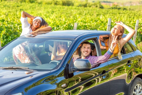 Happy Friends Waving Hands Open Window Car Road Trip Vineyards Stock Picture