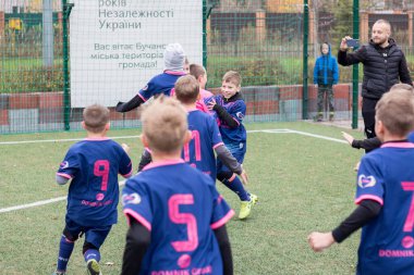 Çocuklar savaş sırasında Ukrayna 'daki futbol sahasında futbol oynuyor.