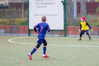 Çocuklar savaş sırasında Ukrayna 'daki futbol sahasında futbol oynuyor.