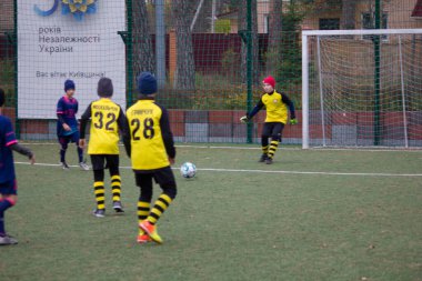 Çocuklar savaş sırasında Ukrayna 'daki futbol sahasında futbol oynuyor.