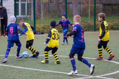 Çocuklar savaş sırasında Ukrayna 'daki futbol sahasında futbol oynuyor.