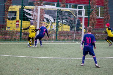 Çocuklar savaş sırasında Ukrayna 'daki futbol sahasında futbol oynuyor.