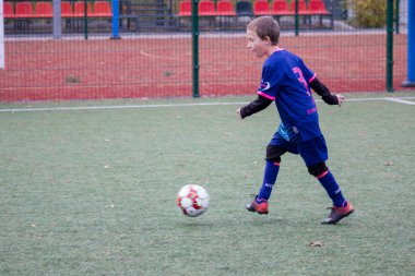 Çocuklar savaş sırasında Ukrayna 'daki futbol sahasında futbol oynuyor.