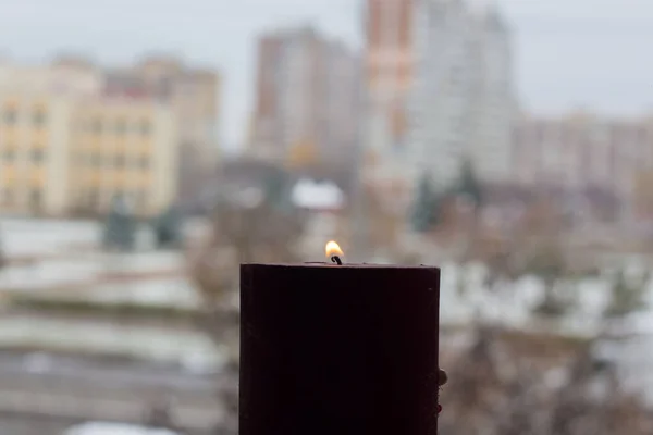 キエフの光のない複数階建ての建物の背景に燃えるろうそく ウクライナでの戦争による停電 — ストック写真