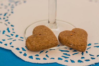 Romantic dinner for Valentine's Day. Heart shaped cookies and glasses for lovers