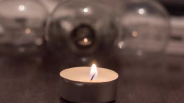 A burning candle against the background of lamps and power banks. Blackout due to war in Ukraine