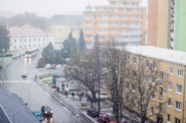 Flying snow in the winter on the background of the street