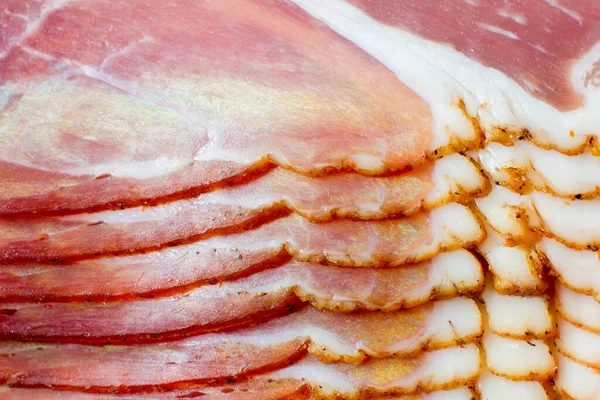 Piecese of raw smoked pork ham on white background.