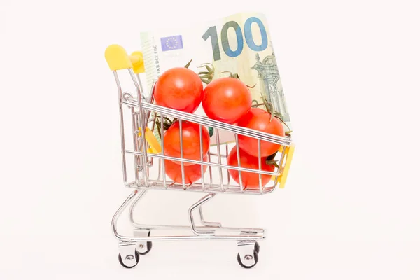 stock image Tomatoes and a banknote in a consumer basket . Rising food prices.