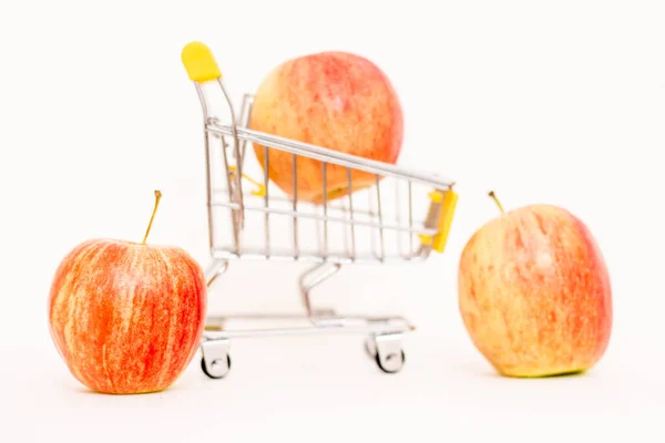 stock image Apples in a toy consumer basket. Inflation, rising food prices.