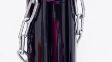 Bir şişe şarabın üzerinde kilit olan zincir..