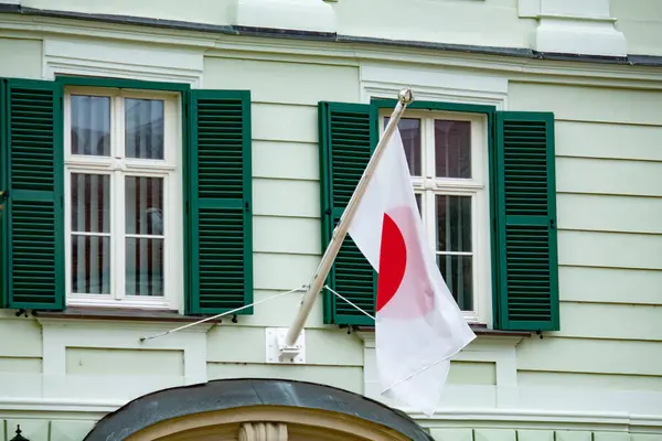 Japanese flag near a house in Europe close-up