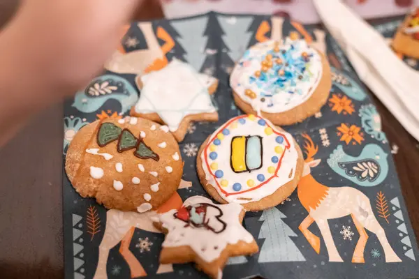 Children decorate cookies for New Year and Christmas