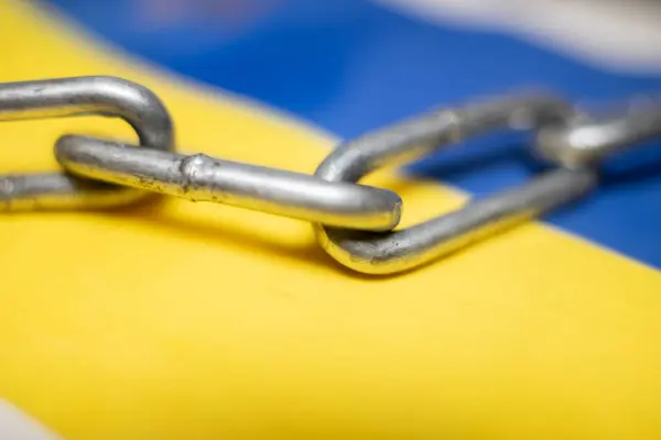 Metal chain on the Ukrainian flag. Ban on citizens leaving the country