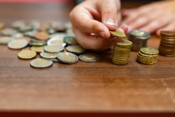 Stock image Child's Hands and Coins: Europe's Aid to Ukrainian Refugees Cuts