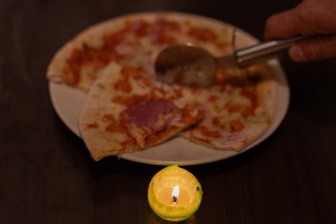 Cooking Pizza by Candlelight. No electricity due to war in Ukraine clipart