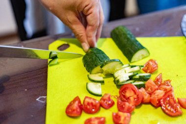 Salata için salatalık ve domates dilimliyorum.