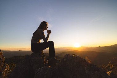silhouette of Religious young woman praying to God in the morning, spirtuality and religion, Religious concepts