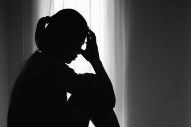 Asian woman sitting on the house area Feeling sad, tired and worried about depression, mental health problems and heartbreaking concept.