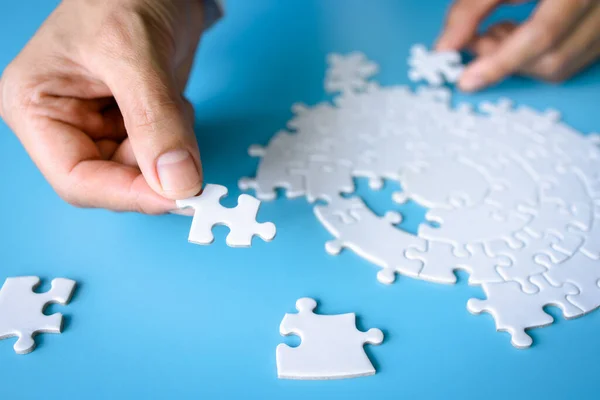 Hand holding a jigsaw puzzle. jigsaw puzzle Solve problems working together Organize team building connection plan Choosing the right business.