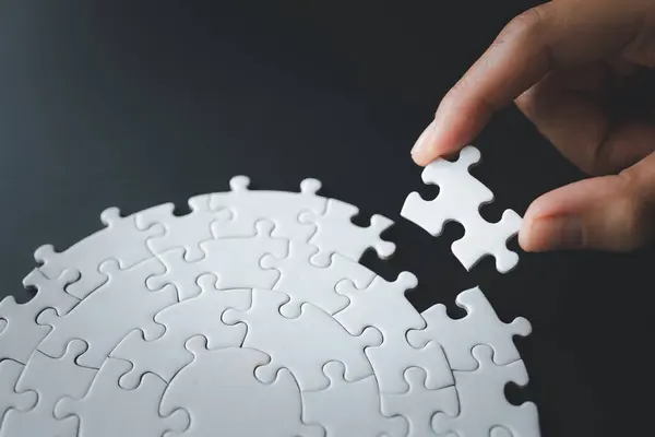 Hand put the last piece of jigsaw puzzle to complete the mission, Business solutions, success and strategy concept, The solution includes completing the mission.