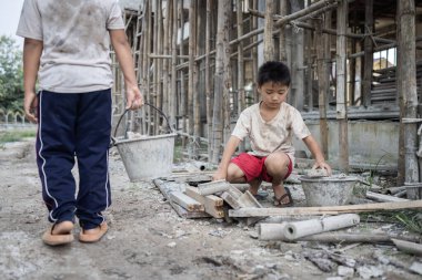 Children working at construction site. Concept against child labor and human trafficking for world day against child labor concept.